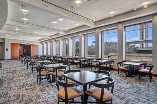 a row of tables and chairs in a room with windows at Hyatt Regency DFW International Airport in Dallas