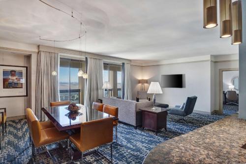 a hotel room with a desk and a living room at Hyatt Regency DFW International Airport in Dallas