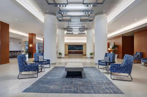a lobby with chairs and a table in a building at Hyatt Regency DFW International Airport in Dallas