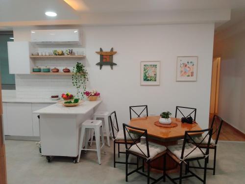 a kitchen with a table and a table and chairs at Beautiful beach apartment in Ashdod