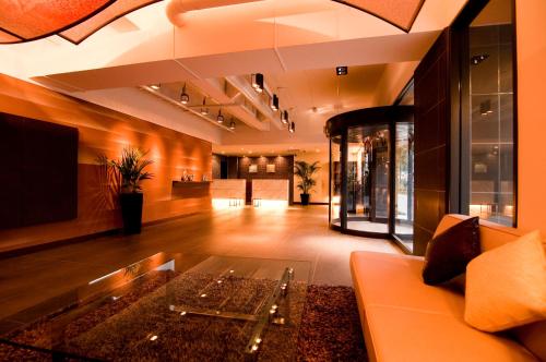 a lobby with a couch and a glass table at Hotel Sunflex Kagoshima in Kagoshima