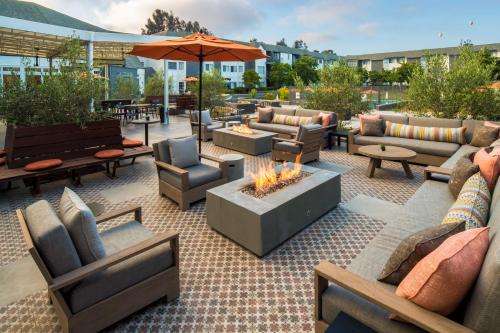 an outdoor patio with couches and a fire pit at Hilton San Diego/Del Mar in San Diego