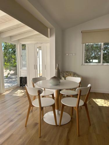 a dining room with a table and chairs at Quinta Verde Algarve in Medronhal