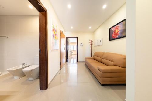 un salon avec un canapé et des toilettes dans l'établissement Baleal Deluxe Apartments, à Baleal