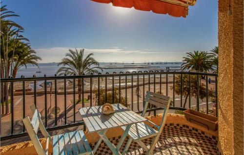 a balcony with a table and chairs and the beach at Nice Home In San Javier With Wifi in San Javier