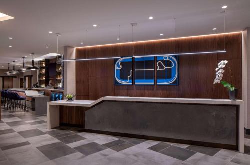 a lobby with a nhl sign on the wall at Hyatt Place Indianapolis Downtown in Indianapolis