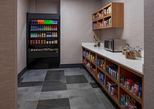 a drink station in a restaurant with a large refrigerator at Hyatt Place Indianapolis Downtown in Indianapolis
