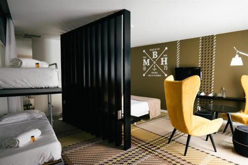 a room with a bed and a desk and a chair at Macarico Beach Hotel in Praia de Mira