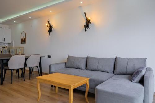 a living room with a couch and a table at Körfez Residence in Fethiye