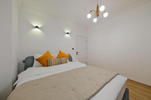 a bedroom with a large bed with orange pillows at Körfez Residence in Fethiye