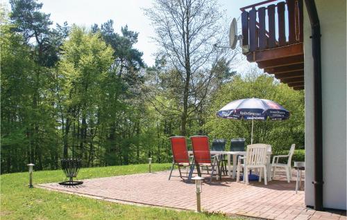 a patio with a table and chairs and an umbrella at Ferienhaus 15 In Kirchheim in Kirchheim