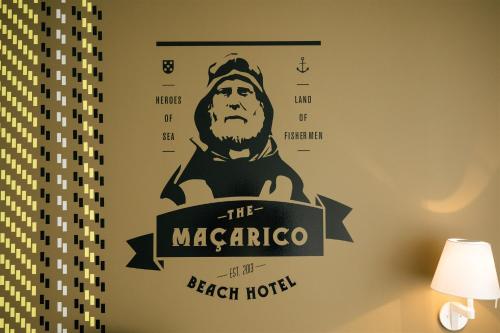 a sign for the macarthur beach hotel on a wall at Macarico Beach Hotel in Praia de Mira