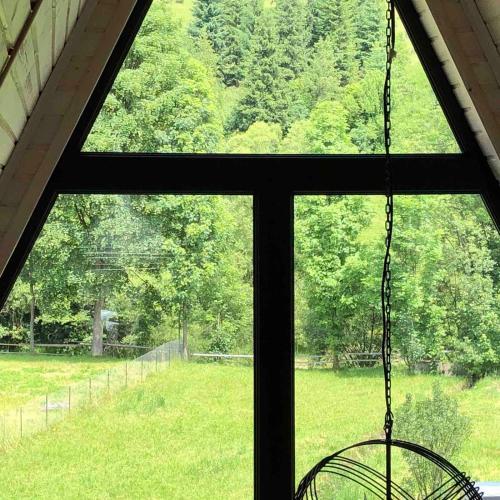 a window with a view of a field of grass at Soul House in Pilipets