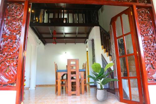 a dining room with a table and chairs at Bella Vista Villa in Seeduwa