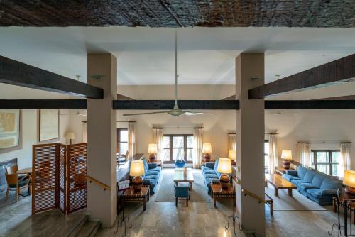 a large living room with blue couches and chairs at Parador de Melilla in Melilla