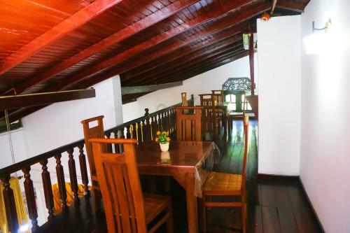 a dining room with a wooden table and chairs at Bella Vista Villa in Seeduwa