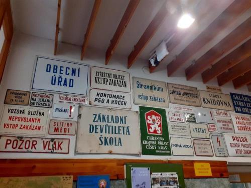 a wall with many signs on the wall at Penzion Kukla in Kuklík