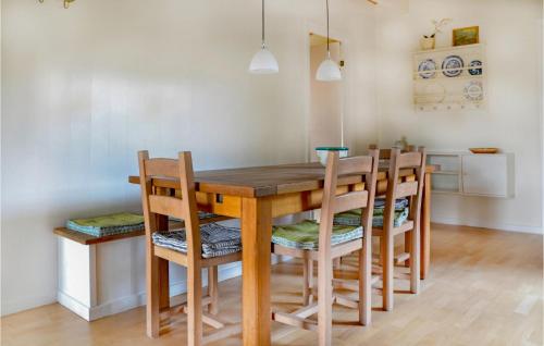 a dining room with a wooden table and chairs at Holiday Home Nybyvej Fanø Vi in Fanø