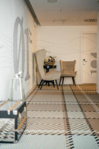 a living room with a table and two chairs at Macarico Beach Hotel in Praia de Mira