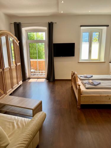 a living room with two beds and a couch at Gasthof Löwen in Pfronten