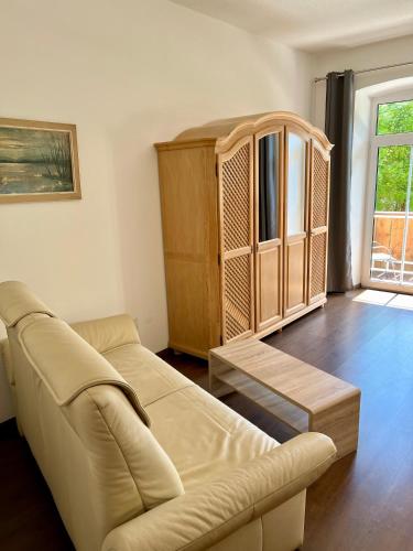 a living room with a couch and a cabinet at Gasthof Löwen in Pfronten