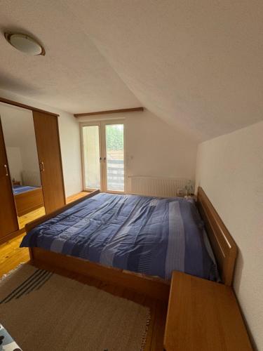 a bedroom with a bed in a room with a window at Villa RELAX Miševići in Sarajevo