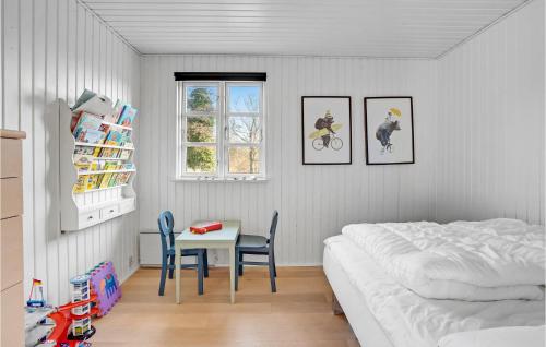 a bedroom with a bed and a table and chairs at Lovely Home In Haderslev With Wifi in Haderslev