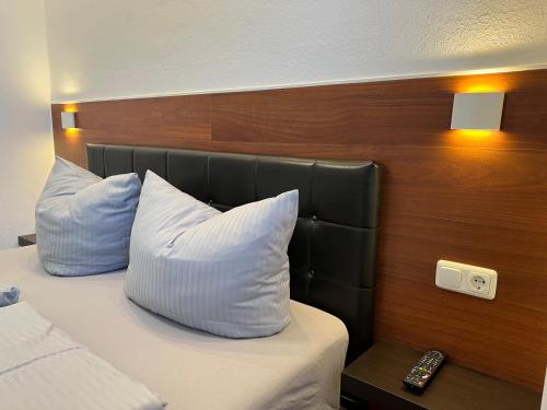 a hotel room with a bed with two pillows at Gasthof Löwen in Pfronten