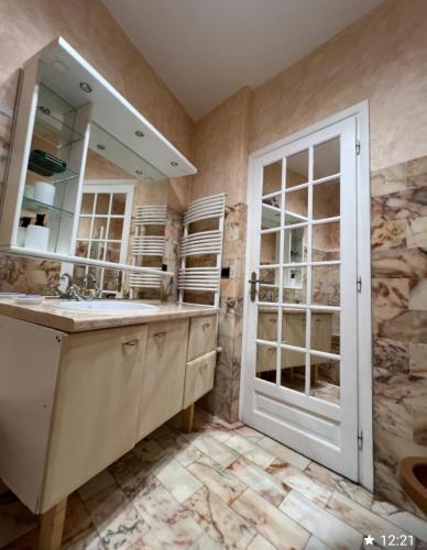 une salle de bain avec un lavabo et un miroir dans l'établissement Charmant studio, à Villeneuve-Loubet