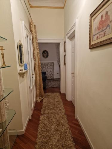 a hallway of a home with a rug on the floor at Appartamenti INCORONATA in Lodi