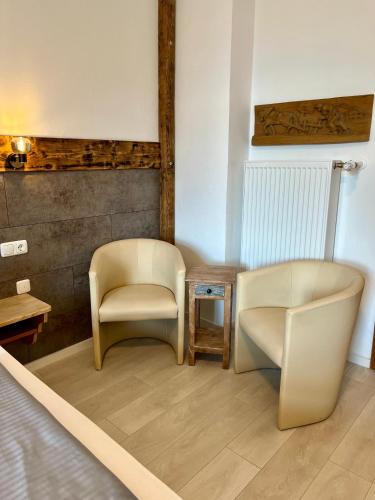 a room with two chairs and a table at Gasthof Löwen in Pfronten
