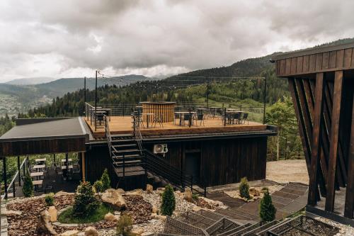 a house with a deck with a table on it at Mandra Morion in Ogrody