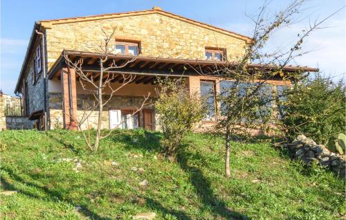 an old stone house on a hill with grass at Stunning Home In Monterotondo Marittimo in Monterotondo
