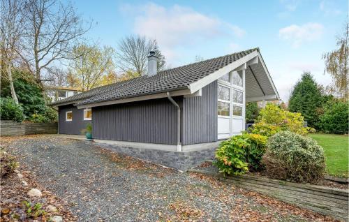 a small house with a gravel driveway at 2 Bedroom Lovely Home In Aabenraa in Aabenraa