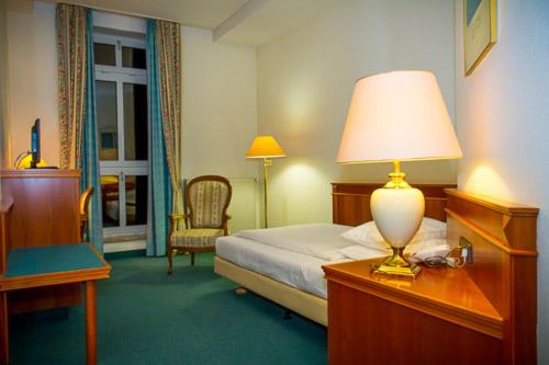 Una cama o camas en una habitación de Hotel de Weimar