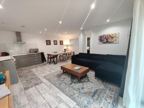 a living room with a couch and a table at Les chambres du Chateau de Fenestrelle in Aubagne