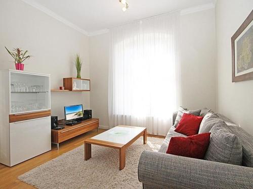 a living room with a couch and a coffee table at Jagdschloß zu Hohen Niendorf Fewo 5 in Hohen Niendorf