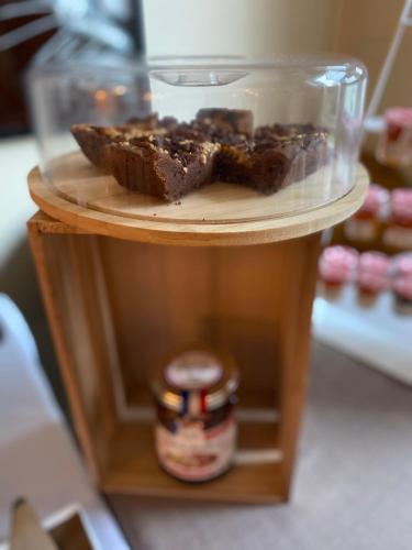 a plate of chocolate muffins on a shelf with a jar at Le Regina Hôtel restaurant in Hardelot-Plage
