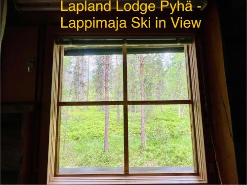 a window with a view of a forest at Lapland Lodge Pyhä Ski in, sauna, free WiFi, national park - Lapland Villas in Pyhätunturi