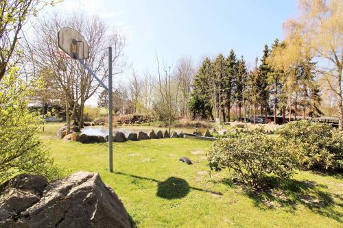 a basketball hoop in a park with a rock at Ostseeresidenz Appartements Wischuer Fewo 36 in Wischuer