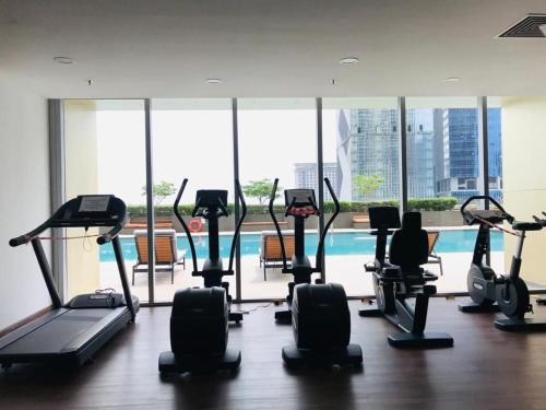 a gym with treadmills and ellipticals in a building at The PeAk Residence, Multi-Apartment by Emma in Phnom Penh
