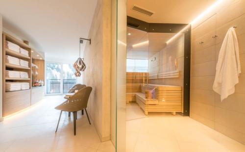 a small bathroom with a chair and a closet at Heart Hotel Grischuna in Sankt Anton am Arlberg