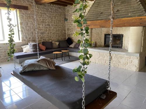 a room with two swing beds and a fireplace at Maison en pleine nature proche plage Omaha Beach! in Mandeville-en-Bessin