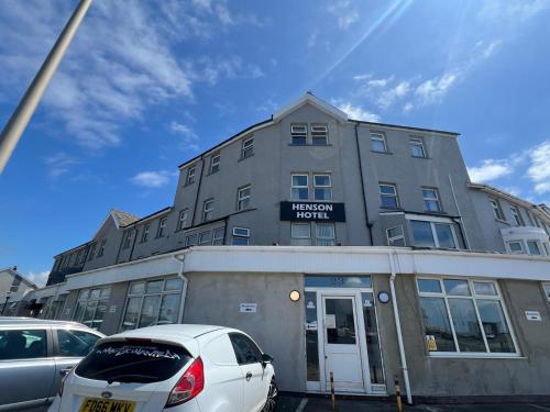 a building with cars parked in front of it at Henson hotel in Blackpool