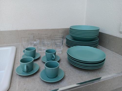 a counter with plates and cups and glasses at Villa Agapanto in Paestum