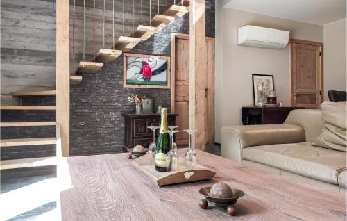 a living room with a table with a bottle of wine at Amazing Home In Knesselare With Sauna in Knesselare