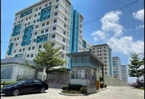 a car parked in front of a large building at 2 Bedroom Condo Iloilo City in Iloilo City