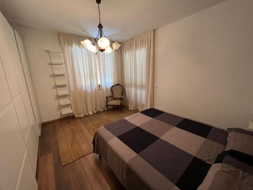 a bedroom with a bed and a chair in it at Loft delle meraviglie in Vallecchia