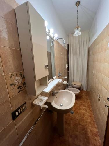 a bathroom with two toilets and a sink and a mirror at Loft delle meraviglie in Vallecchia