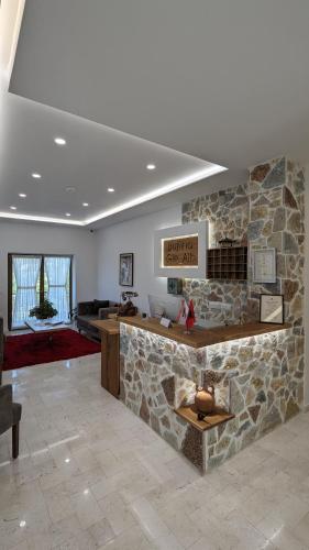 a lobby with a stone counter and a stone wall at Gle-Alb AgroTourism in Tepelenë
